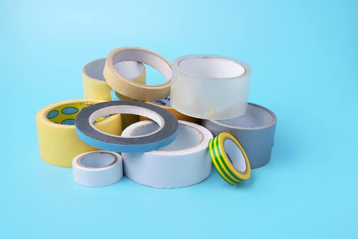 many different kind of scotch tapes on a blue background.