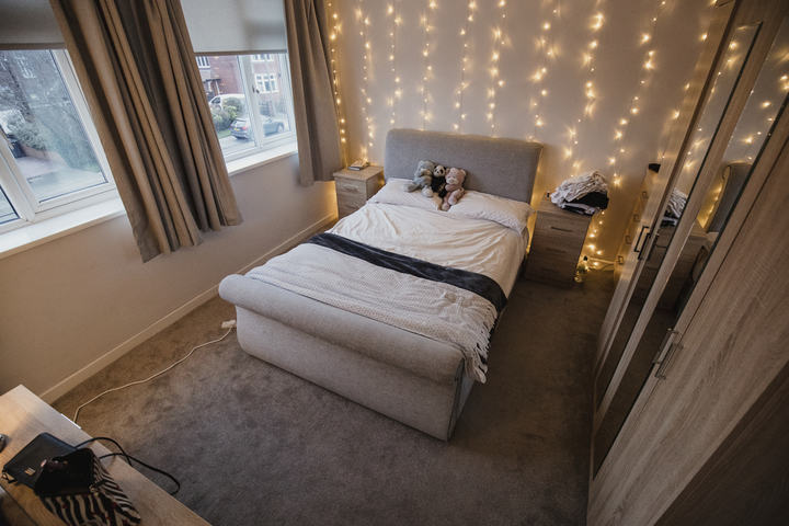 bedroom with rope lights wall
