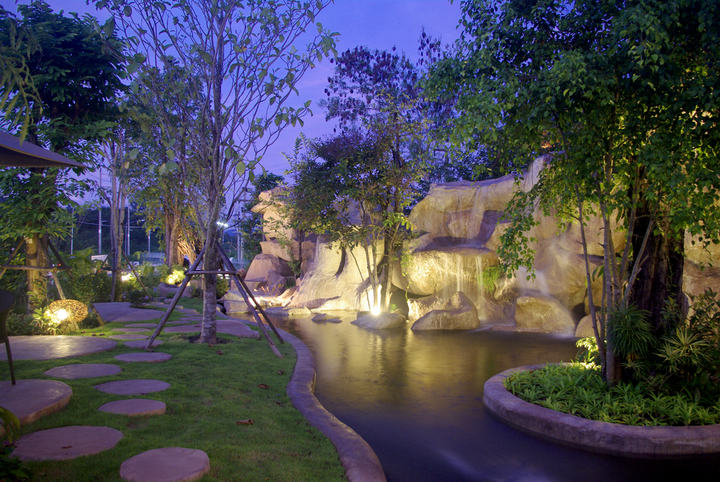 beautiful waterfall in the garden at night with lighting