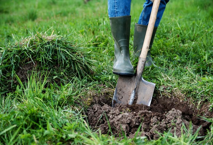 Man digs a hole in the ground