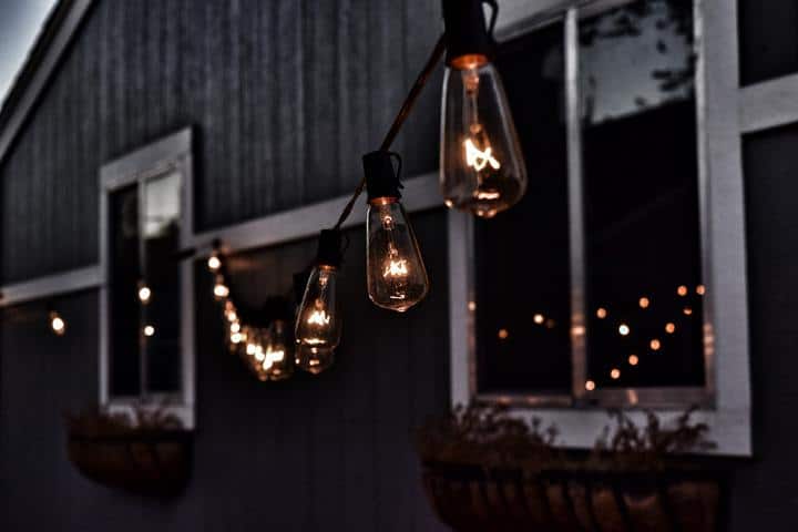 hanging patio lights in dark with two windows