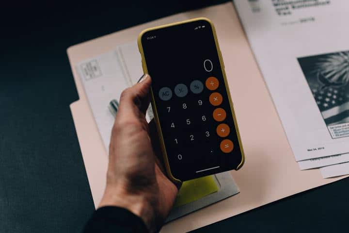 Mobile calculator with papers on the table