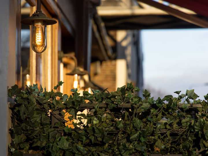 Hanging outdoor landscape lights by the house entrance