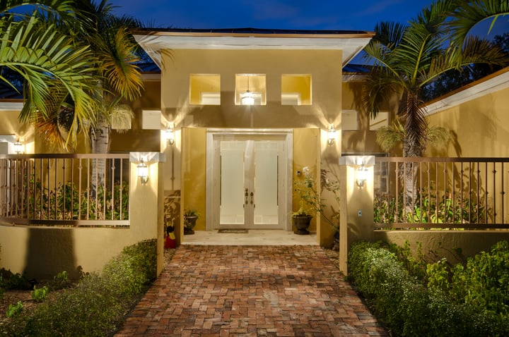 View of front door of residence with glass door.