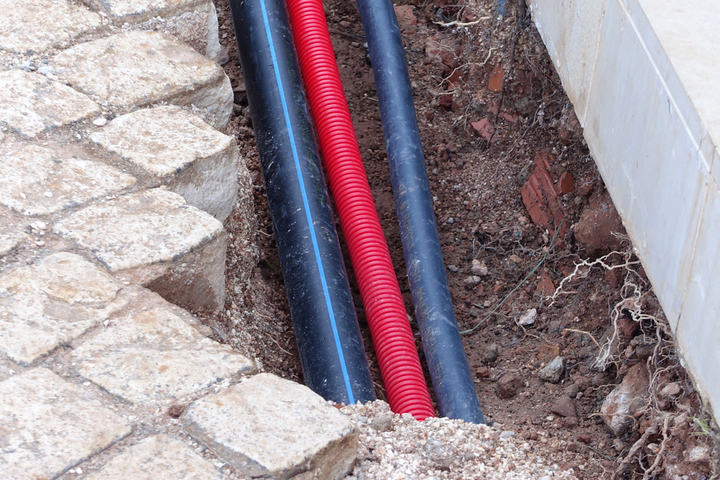 Pipes and cables being laid under driveway