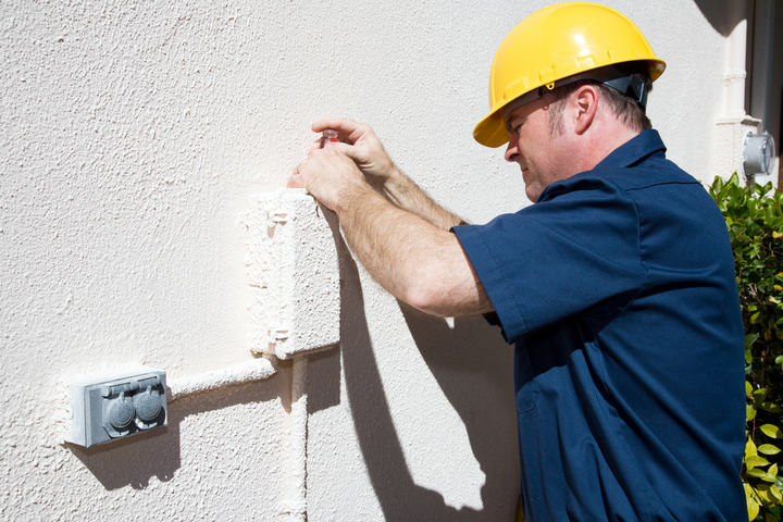 Repairman opening an outdoor box