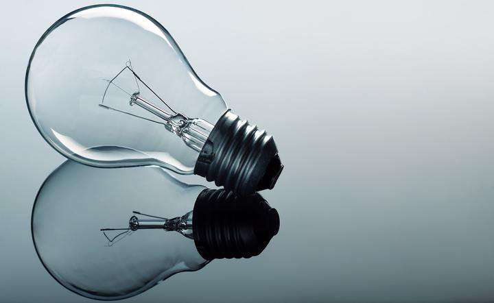 a mirrored light bulb on grey background