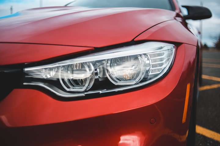 close up shot of red car headlight