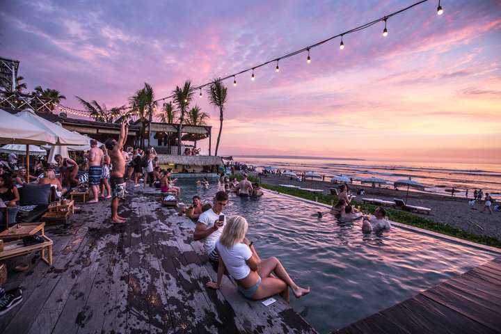 Evening pool party with string lights above