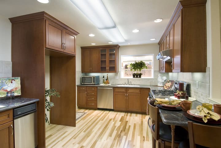 modern kitchen with wood floor and recessed lights