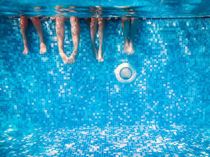 legs in pool with lights