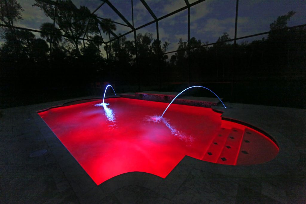 A Swimming Pool lit up at Night