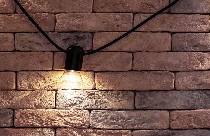 Electric lamp on a brick wall background