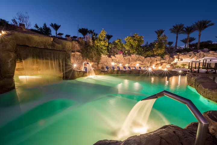  Evening view for a luxury swimming pool in night illumination 