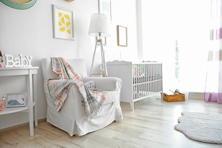 Interior of modern baby room with table lamp