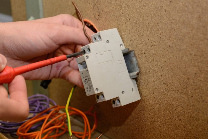 Electrician installing a surge switch