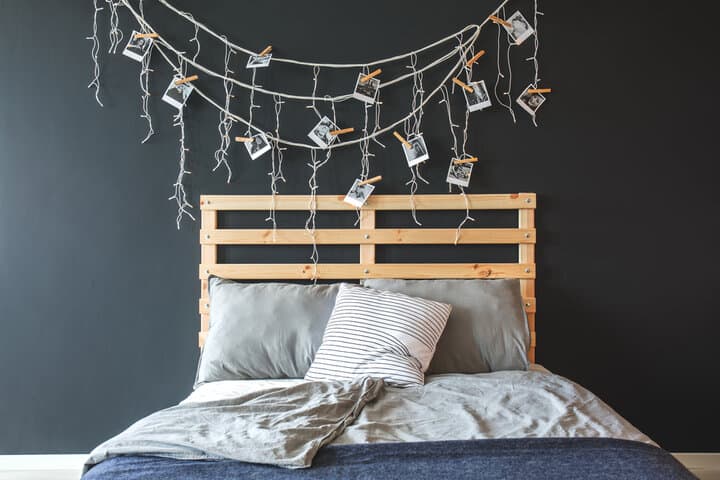 bed with headboard decorated with string lights
