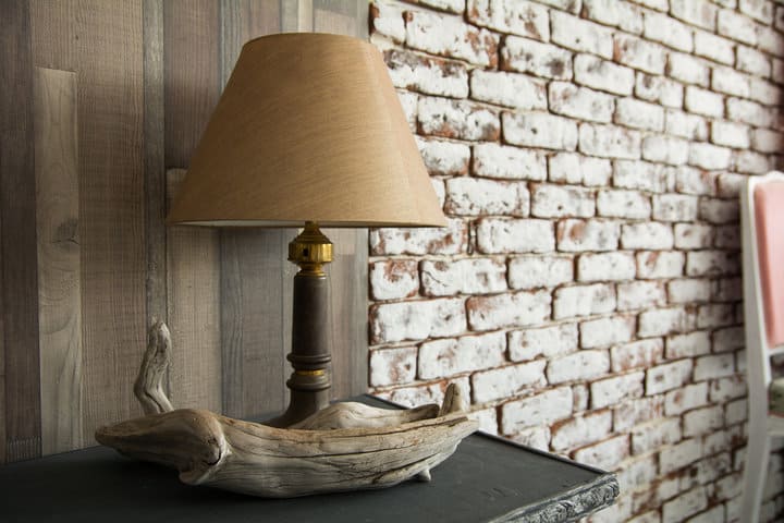  table lamp with shade on the background of a wooden and brick wall